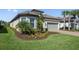 Charming home with a tile roof, manicured landscaping, and a paved driveway at 11414 Juglans Dr, Odessa, FL 33556