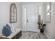 Well-decorated foyer with wood-look tile, a decorative mirror, and bench at 11414 Juglans Dr, Odessa, FL 33556