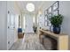 Bright foyer with wood-look tile, stylish light fixture, decorative accents, and ample space at 11414 Juglans Dr, Odessa, FL 33556
