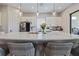 Bright kitchen features a large island with quartz countertops, pendant lighting, and stainless steel appliances at 11414 Juglans Dr, Odessa, FL 33556