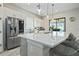 Modern kitchen features stainless steel appliances, island, and white cabinetry at 11414 Juglans Dr, Odessa, FL 33556