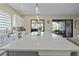 Bright kitchen features white cabinetry, center island, and pendant lighting at 11414 Juglans Dr, Odessa, FL 33556