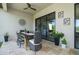 Enjoy dining outdoors in this covered patio area, complete with stylish decor and garden views at 11414 Juglans Dr, Odessa, FL 33556
