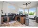 A covered outdoor kitchen features built-in grill, sink, and counter space with seating and views of the pool at 11414 Juglans Dr, Odessa, FL 33556