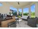 Covered outdoor living area featuring a wet bar and comfortable seating area with views of the lake at 11414 Juglans Dr, Odessa, FL 33556