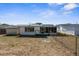 View of the fenced backyard with a shed and covered back porch at 11422 Yellowwood Ln, Port Richey, FL 34668