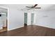 Bedroom with wood-look floors and entrances to bathroom and closet at 11422 Yellowwood Ln, Port Richey, FL 34668