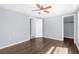 Bedroom featuring a ceiling fan, wood-look floors and closet at 11422 Yellowwood Ln, Port Richey, FL 34668