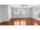 Bright bedroom with hardwood floors, large windows, and neutral color palette at 11422 Yellowwood Ln, Port Richey, FL 34668