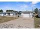 Single-story home featuring an attached garage, solar panels, and well-maintained driveway at 11422 Yellowwood Ln, Port Richey, FL 34668