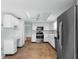 A full kitchen view with stainless steel appliances and white cabinets at 11422 Yellowwood Ln, Port Richey, FL 34668