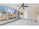Sunroom featuring lots of windows, a ceiling fan, and access to the backyard at 11422 Yellowwood Ln, Port Richey, FL 34668