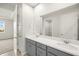 Bathroom with dual sinks, large mirror and views to bedroom and closet at 12323 Hearts Ease St, Venice, FL 34293