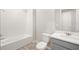 Bright bathroom featuring tiled shower and modern vanity with wood-look flooring at 12323 Hearts Ease St, Venice, FL 34293