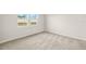 Bedroom with carpet and large window providing natural light at 12323 Hearts Ease St, Venice, FL 34293