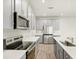 Beautiful kitchen with stainless steel appliances, gray cabinetry, quartz countertops, and a sleek design at 12323 Hearts Ease St, Venice, FL 34293