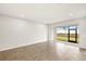 Spacious living area has tile floors and sliding doors to the patio at 12323 Hearts Ease St, Venice, FL 34293