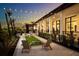 Outdoor lounge area featuring comfortable seating and charming string lights for evening enjoyment at 12323 Hearts Ease St, Venice, FL 34293