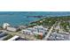 Aerial view of a condo complex near the water with marina, boat access and ample parking at 131 Bluff View Dr # 101, Belleair Bluffs, FL 33770