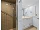 Bathroom with enclosed shower, vanity with large mirror, and light-colored countertop and cabinets at 131 Bluff View Dr # 101, Belleair Bluffs, FL 33770
