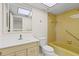 Bathroom featuring a vanity, toilet, and a tiled shower/tub with natural light from a skylight at 131 Bluff View Dr # 101, Belleair Bluffs, FL 33770