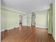 Bright bedroom with wood floors, green walls and curtains, with doorway views into adjacent rooms at 131 Bluff View Dr # 101, Belleair Bluffs, FL 33770
