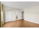 Bright bedroom with warm laminate floors and neutral walls creating a comfortable living space at 131 Bluff View Dr # 101, Belleair Bluffs, FL 33770
