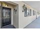 Condominium entrance with decorative door and exterior lighting at 131 Bluff View Dr # 101, Belleair Bluffs, FL 33770