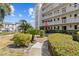 Well-maintained exterior with manicured landscaping and sidewalks, showcasing a beautiful building at 131 Bluff View Dr # 101, Belleair Bluffs, FL 33770