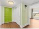 Bright hallway featuring wood floors and a colorful entry door at 131 Bluff View Dr # 101, Belleair Bluffs, FL 33770