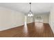 Open living room with hardwood floors, contemporary lighting, and neutral walls at 131 Bluff View Dr # 101, Belleair Bluffs, FL 33770