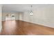 Spacious living room with hardwood floors, slider door, and classic trim at 131 Bluff View Dr # 101, Belleair Bluffs, FL 33770