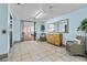Lobby with tile flooring, a large mirror, seating area, and an open doorway with views of parked cars at 131 Bluff View Dr # 101, Belleair Bluffs, FL 33770