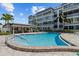Inviting pool area perfect for relaxation, with a clubhouse and lounge chairs nearby at 131 Bluff View Dr # 101, Belleair Bluffs, FL 33770