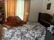 Bedroom showcasing a floral bedspread and dark furnishings at 1312 Foxboro Dr., Brandon, FL 33511