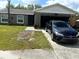 Charming single-story home with a well-maintained lawn and a visible car, displaying curb appeal at 1312 Foxboro Dr., Brandon, FL 33511