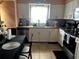 Bright kitchen with white cabinets, tiled backsplash, and modern appliances at 1312 Foxboro Dr., Brandon, FL 33511