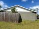 View of the side of the home with wood fence and partial grassy yard at 1312 Foxboro Dr., Brandon, FL 33511