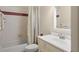 The bathroom features a shower-tub combo, a white sink, and traditional tile at 15014 Arbor Hollow Dr, Odessa, FL 33556