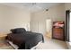 This bedroom features a comfortable bed and an ensuite bathroom for added convenience at 15014 Arbor Hollow Dr, Odessa, FL 33556