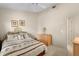 This bright bedroom features a queen bed with a floral motif and a coordinating dresser at 15014 Arbor Hollow Dr, Odessa, FL 33556