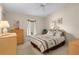 This bright bedroom features a queen bed with a floral motif and a coordinating dresser at 15014 Arbor Hollow Dr, Odessa, FL 33556