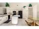 Spacious kitchen featuring white cabinets, modern appliances, and an adjacent dining area for convenience at 15014 Arbor Hollow Dr, Odessa, FL 33556