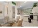 Bright eat-in kitchen boasts white cabinets, modern appliances, tile floors, and decorative plants at 15014 Arbor Hollow Dr, Odessa, FL 33556