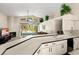 Open kitchen with sleek countertops, modern appliances, and seamless flow to the living area and fireplace at 15014 Arbor Hollow Dr, Odessa, FL 33556