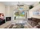 Cozy living room with a fireplace, high ceilings, and a view of the pool at 15014 Arbor Hollow Dr, Odessa, FL 33556