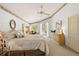 Bright main bedroom showcasing a ceiling fan, large windows, and neutral tones creating a relaxing atmosphere at 15014 Arbor Hollow Dr, Odessa, FL 33556