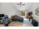Cozy bedroom is complete with light hardwood flooring, a large window, and modern decor at 17557 Fairmeadow Dr, Tampa, FL 33647