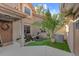Enclosed courtyard with stone fountain, astro turf, seating, and exterior lighting at 17557 Fairmeadow Dr, Tampa, FL 33647