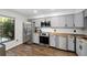 Well-lit kitchen features gray cabinets, stainless steel appliances, and butcher block countertops at 17557 Fairmeadow Dr, Tampa, FL 33647
